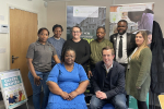 Tom posing for a group photo with carers and staff from Enlightenment Care Services in Oundle.